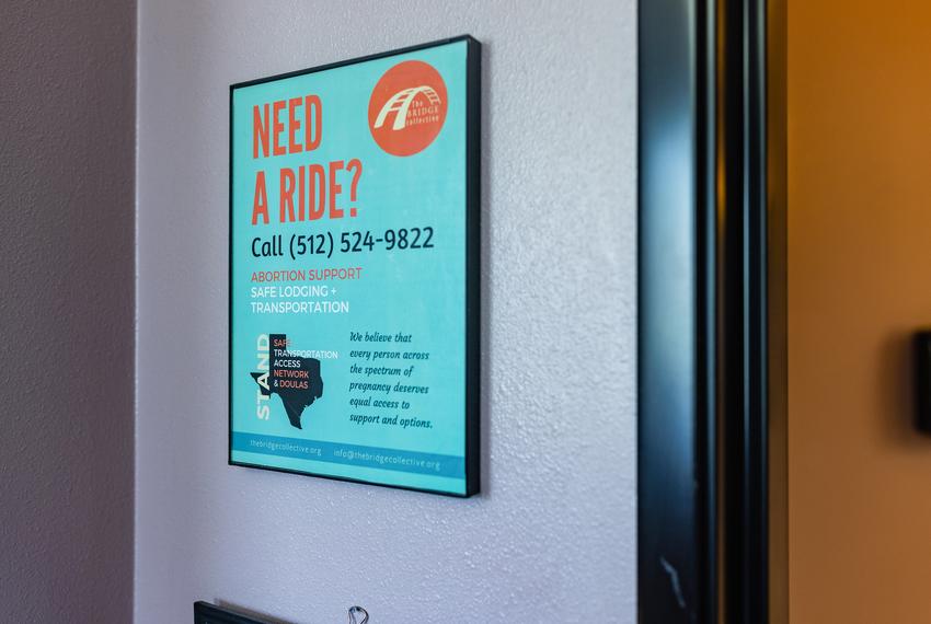 A sign advertising an organization that offers services to abortion patients is on the wall at Whole Women’s Health of Austin on Sept. 1, 2021.