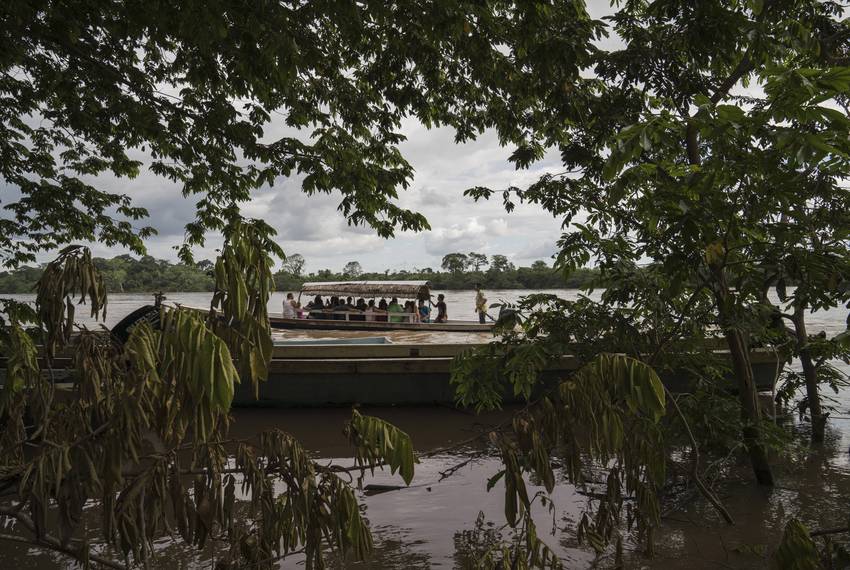 Migrants cross the Usumacinta River between La Técnica, Guatemala and Frontera Corozal, México on Oct. 21. The Usumacinta River acts as a border between the two countries. There is no immigration inspection in either of the two borders in the area.