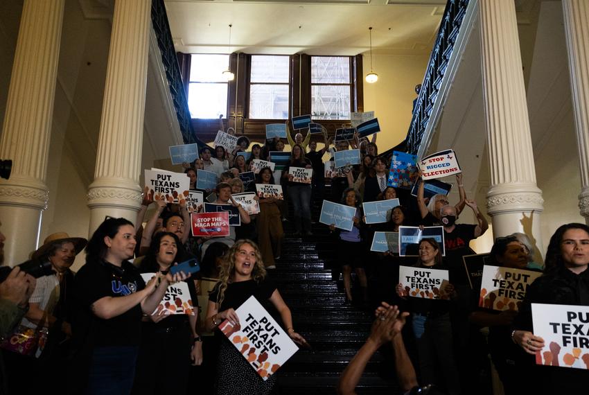 A crowd cheers as representatives walk into the Texas House on Aug. 18, 2025. Texas Democrats left the state to fight redistricting at the national level, returning after two weeks to resume work in the state.