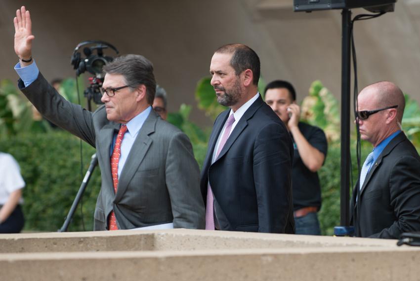 Gov. Rick Perry leaving a pro-Israel rally followed by adviser Jeff Miller on July 30, 2014, at Dallas City Hall.