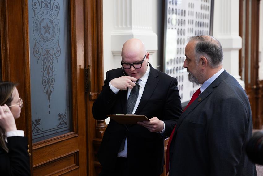 A House staffer checks names of representatives attempting to leave the house floor on Aug. 18, 2025. Members that were absent and had warrants were not allowed to leave from the main door, and had to leave into DPS custody.