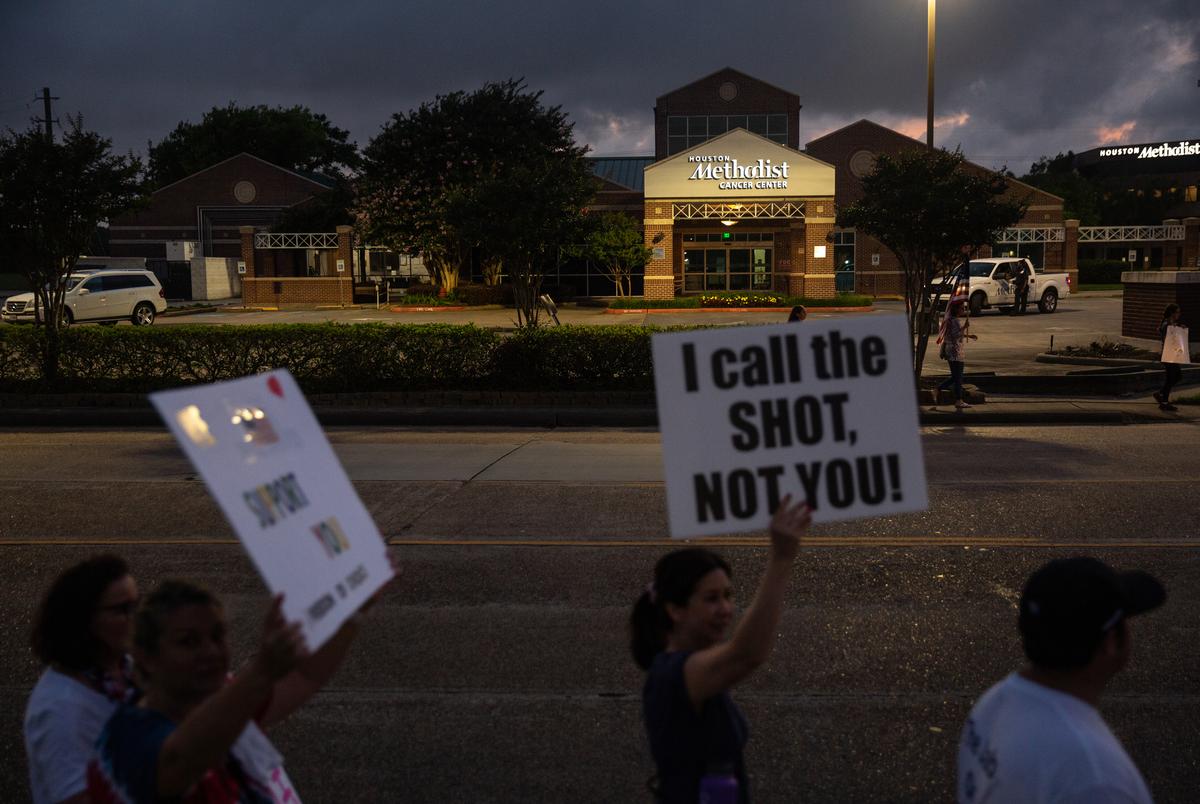 People protest against a COVID-19 vaccine mandate for all hospital employees outside Houston Methodist Hospital in Baytown, Texas on June 7, 2021. Employees who chose not to inoculate themselves by the hospital's Monday deadline faced suspension without pay and job termination, a policy criticized by the protesters as unfair and unauthorized.