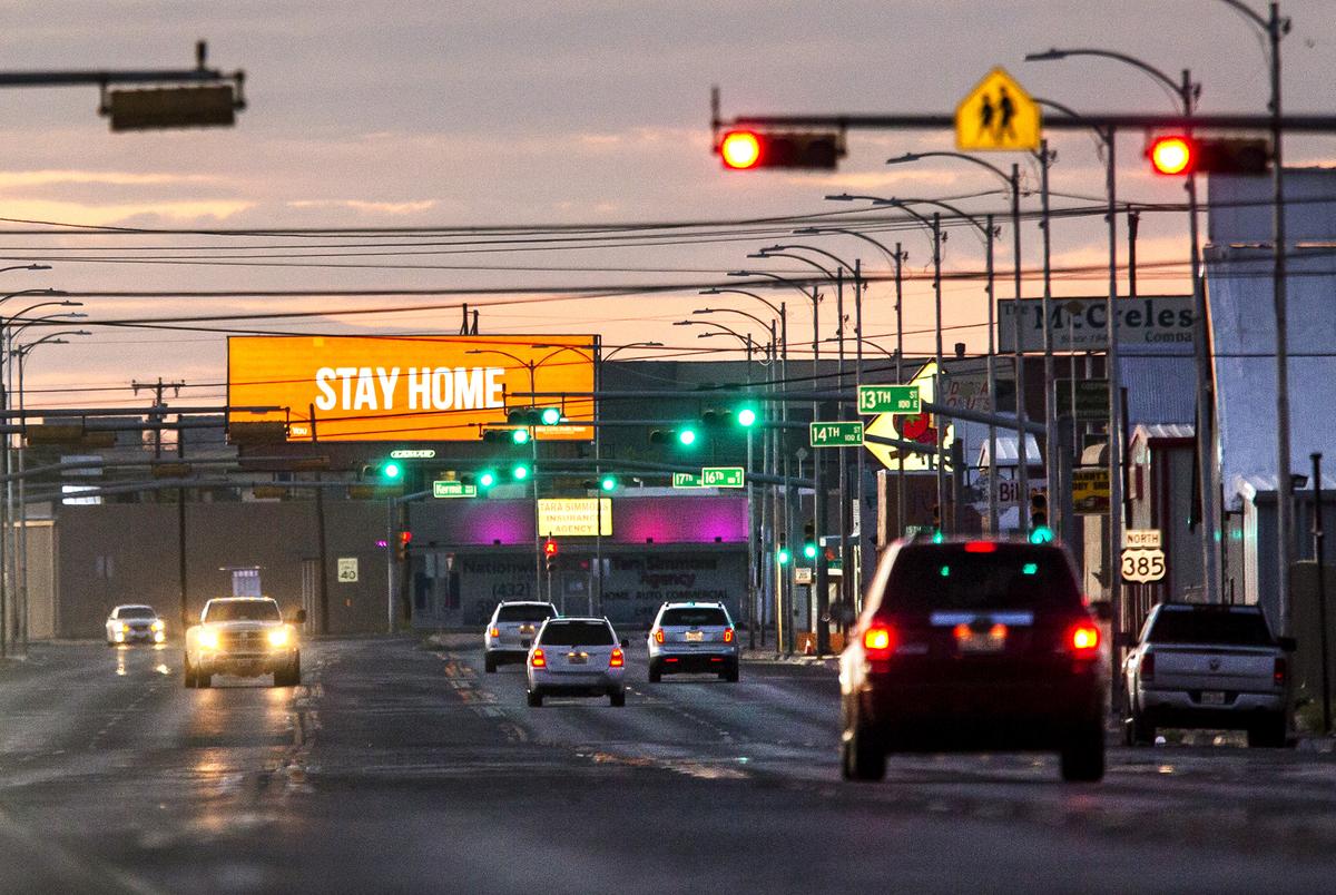 A handful of cars drive down Grant Avenue Thursday evening as an advertisement from Medical Center Hospital urges community members to stay home in Odessa on April 9, 2020.