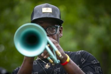 New Orleans musician Dave Washington plays Amazing Grace outside the George Floyd public memorial service.