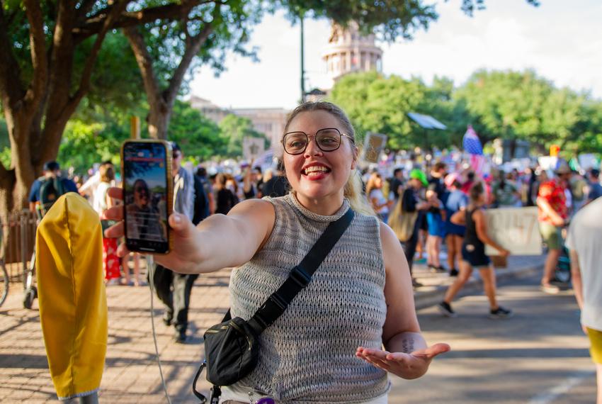 Texas Tribune audience producer goes live on Tik Tok during the “No Kings” protest at the Texas Capitol on June 14, 2025 in Austin, Texas.