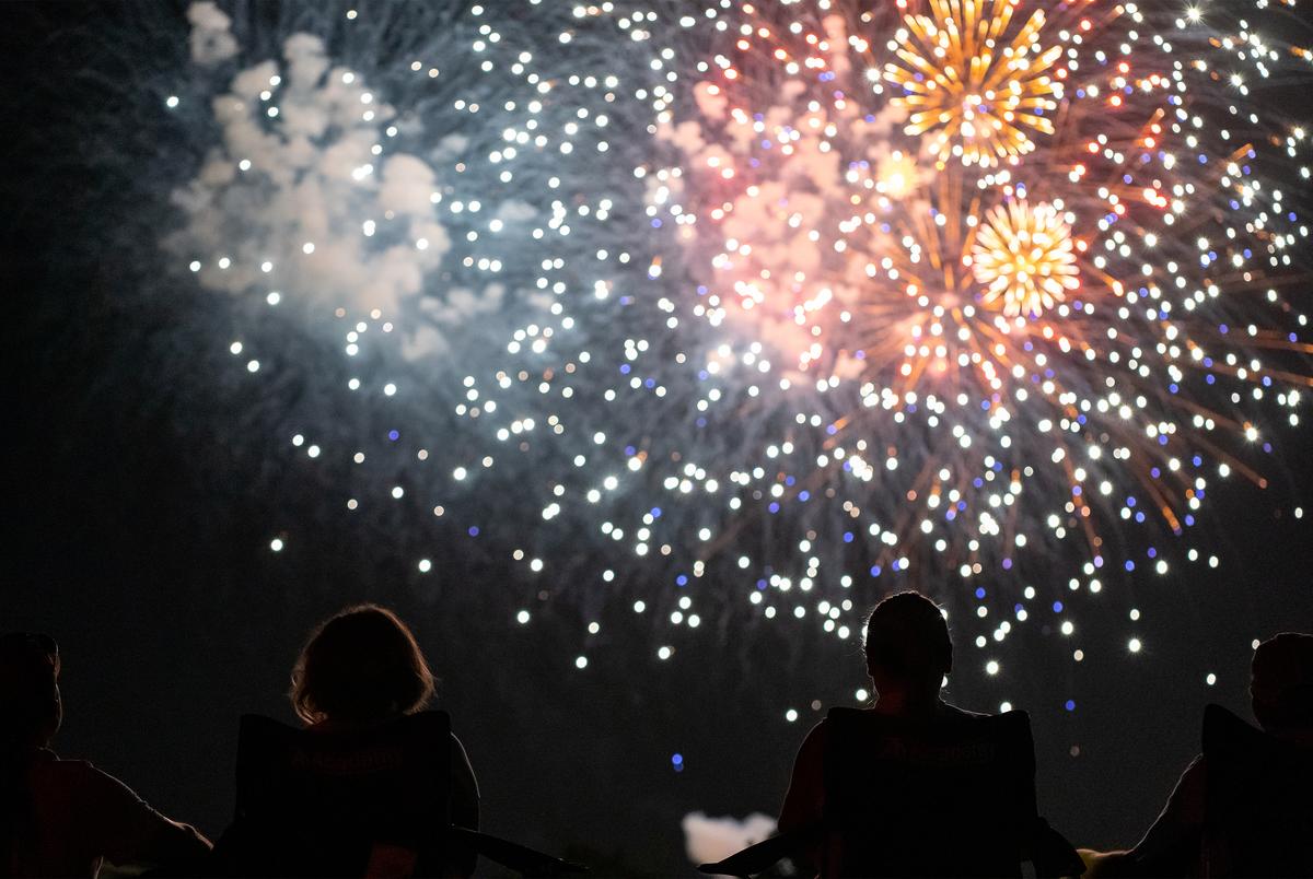 People watch a fireworks display from the parking lot of Church of the Springs in Dripping Springs on July 4, 2020.