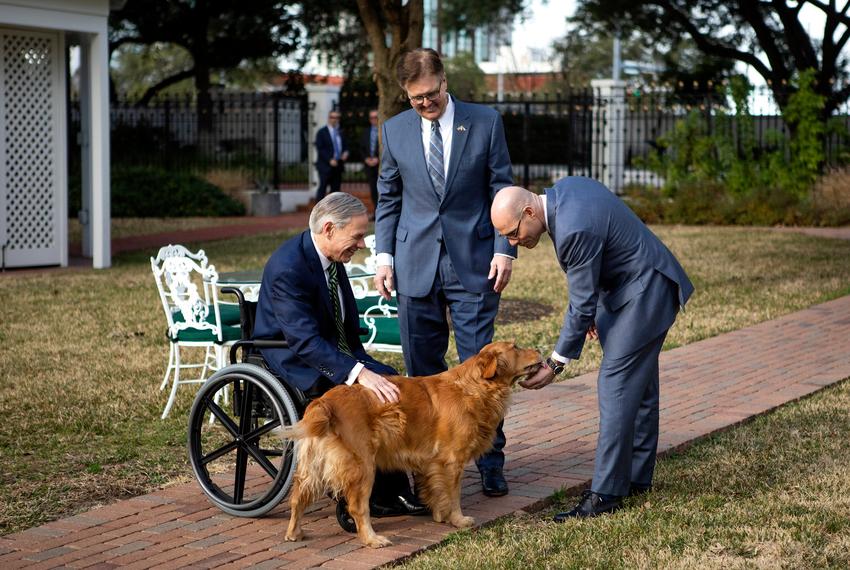 Governor Greg Abott, Lieutenant Governor Dan Patrick, and House Speaker Dennis Bonnen pet Pancake, the governor’s dog after their joint press conference. Jan. 9, 2019.