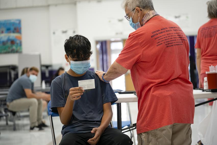 Johan Arzade, 12, looks at his COVID-19 Vaccination Record Card after receiving a dose of the Pfizer vaccine at a clinic organized by the Travis County Mobile Vaccine Collaborative at Rodriguez Elementary School on July 28, 2021.

Source diversity info: Latino Male