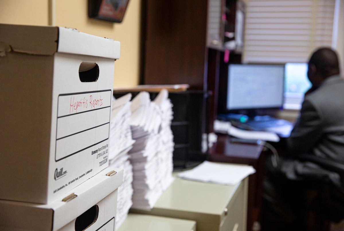 A box of hepatitis reports sit among stacks of information regarding all sorts of diseases at the Northeast Texas Public Health District office in Tyler.