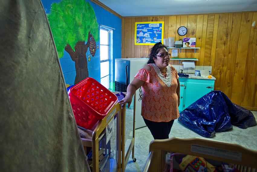 LaVeta Rodriguez, director of the Little Lights Learning Center stands among the unused cribs, toys and equipment in the baby room at the center in Rockport on Oct. 25, 2017. The school was damaged during Hurricane Harvey and has yet to re open. 