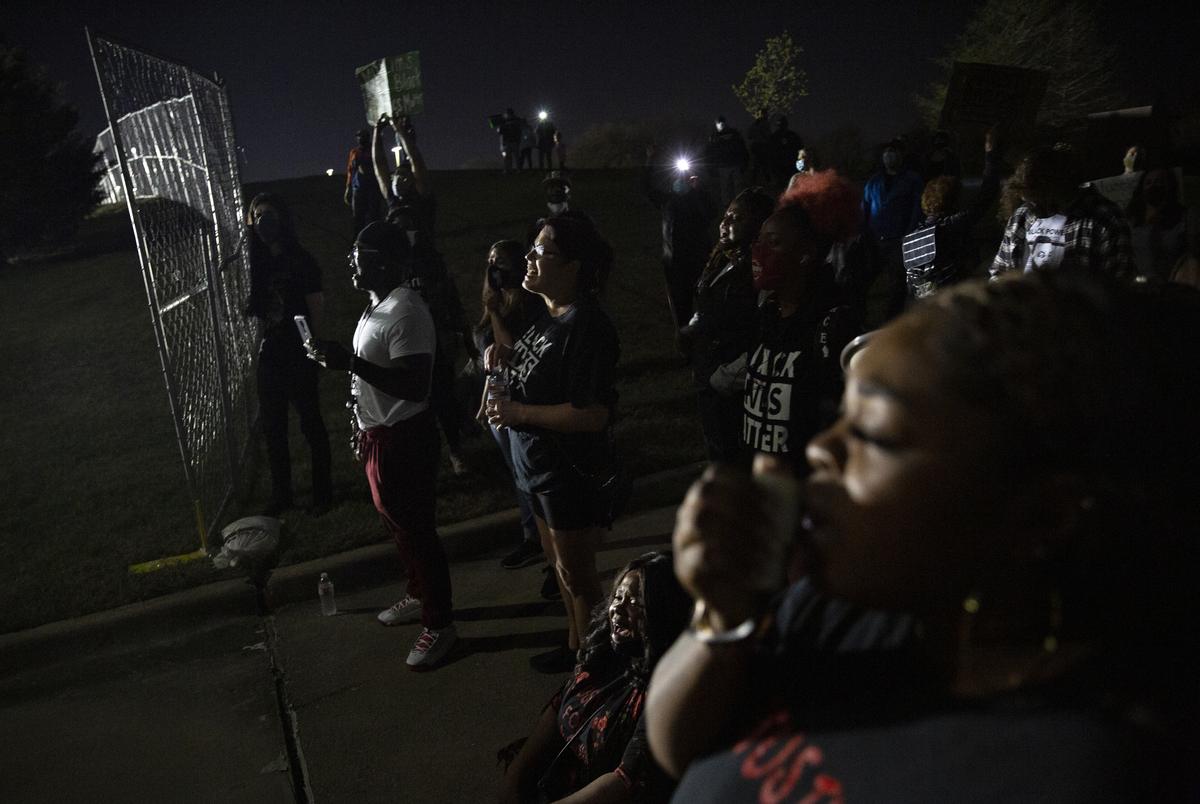 LaChay Batts leads a chant saying Marvin Scott IIIís name at a demonstration outside of the Collin County Jail to demand justice for Marvin Scott III, who died while in custody at the jail on March 14, 2021. Family, friends and supporters have gathered at the jail every night since his death to demand the arrest of the 7 detention officers involved.