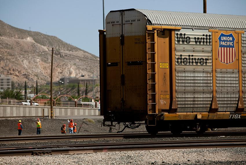 Men work on the railroad tracks at the Union Pacific railyard in El Paso on Tuesday, May 6, 2014.