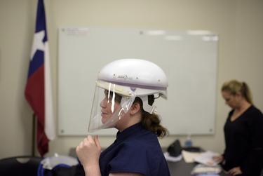 Danielle Teran, an infection control practitioner, wears a face mask during a personal protection equipment training session in Houston on March 12, 2020. 

Mark Felix for The Texas Tribune