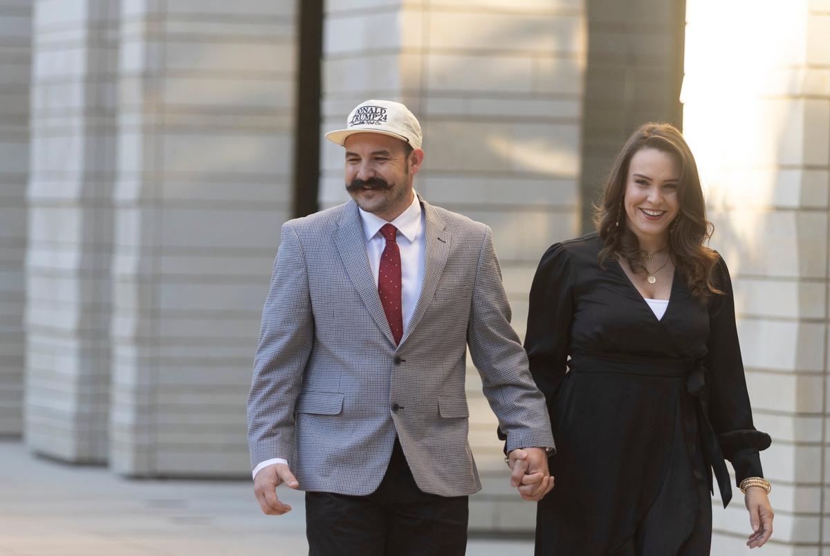 Robert and Joeylynn Mesaros pose for photos outside of a U.S. federal courthouse in Austin, Texas on Sept. 9 ahead of the Trump Train trial.