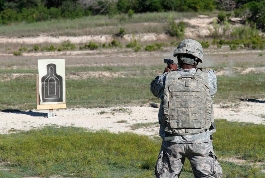 A soldier fires an M9 in a training exercise at Fort Hood Army base.