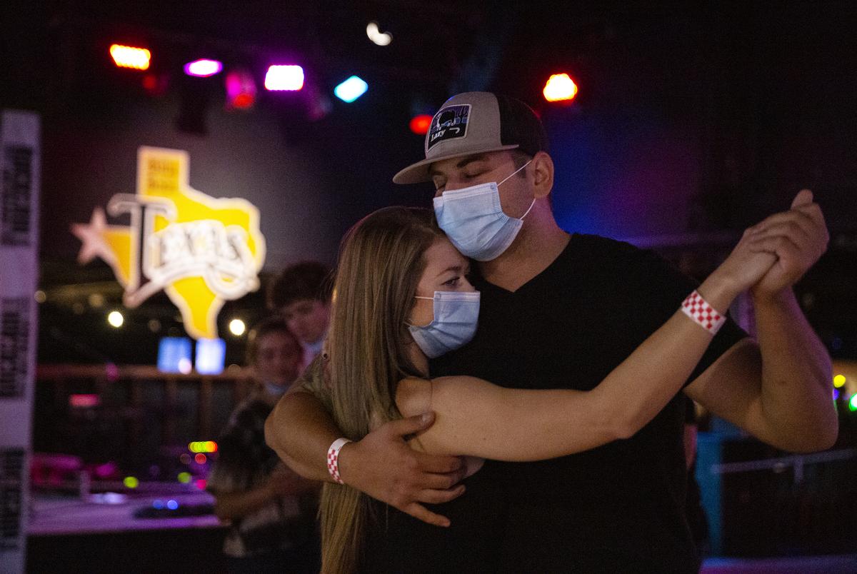 Patrons dance at Billy Bob’s Texas, a honky-tonk in Fort Worth. Billy Bob’s has been operating since August 13th under food and beverage guidelines, after previously being classified as a bar. Bars that did not already get the food and beverage license were allowed to reopen October 14 at 50% capacity, and must stop selling alcohol by 11 pm.