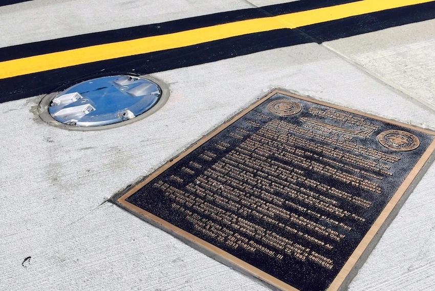 The bronze marker on a taxiway at Love Field, inaccessible to the public, which forever marks the spot where LBJ took the oath of office on November 22, 1963.