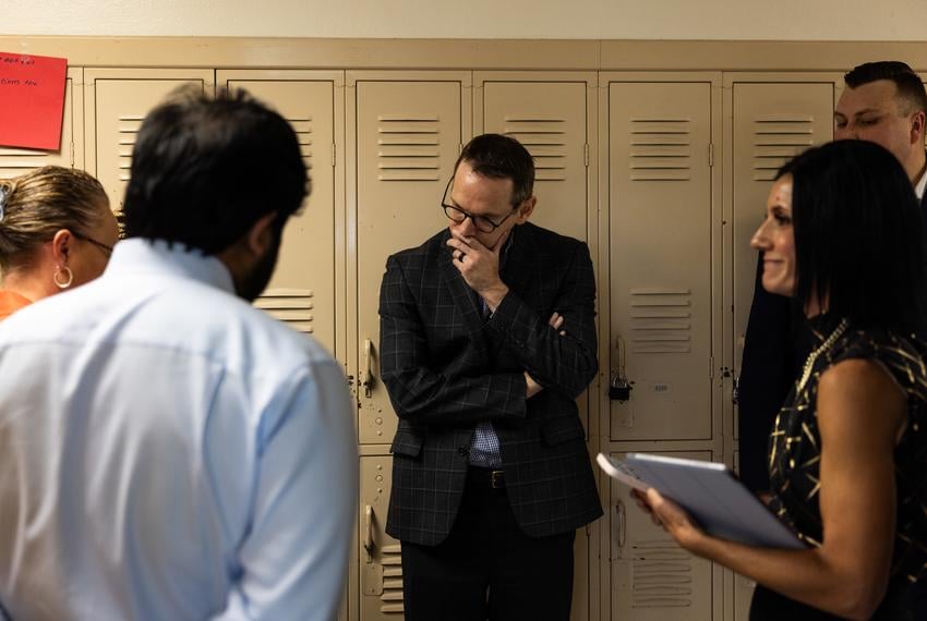 Texas Education Commissioner Mike Morath talks with local and state education officials in the hallway of Fort Worth ISD’s William James Middle School on Aug. 28, 2025.