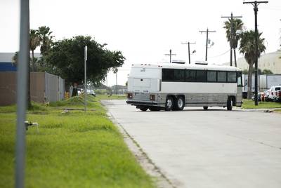 An immigration bus carrying migrants departs the U.S. Border Patrol Central Processing Center known as Ursula in McAllen on Thursday. The bus will drop-off the migrants at the McAllen Bus Station.