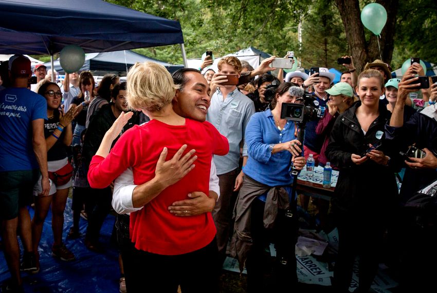 Presidential candidates Julián Castro and Massachusetts Senator and Elizabeth Warren hug as they meet supporters during the Polk County Democrats Steak Fry in Water Works Park in Des Moines, Iowa on Saturday, Sept. 21, 2019