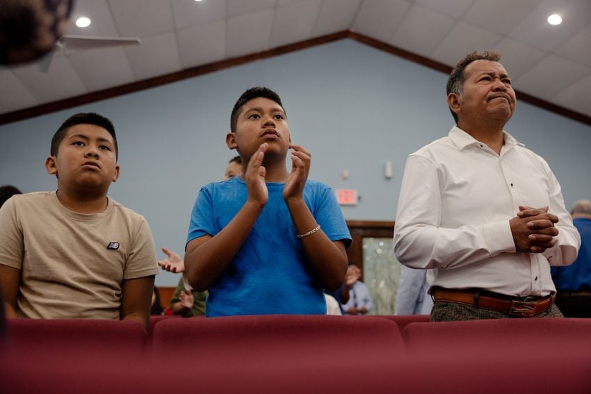 José Avila and his two sons, Jeremiah (left) and Isaac, attend church service at the Iglesia Pentecostal Del Nombre de Jesus on Sunday, June 1, 2025, in Houston.