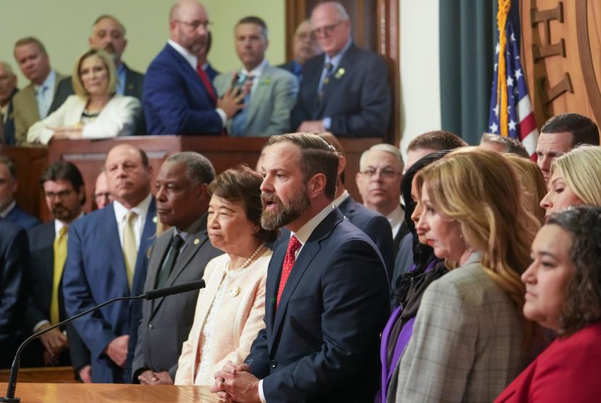 House Speaker Dustin Burrows address the press with a host of Republican members behind him during the Texas House session on August 4, 2025 where less than 100 members registered failing to reach a quorum with the departure of dozens of Democrats out of state.  