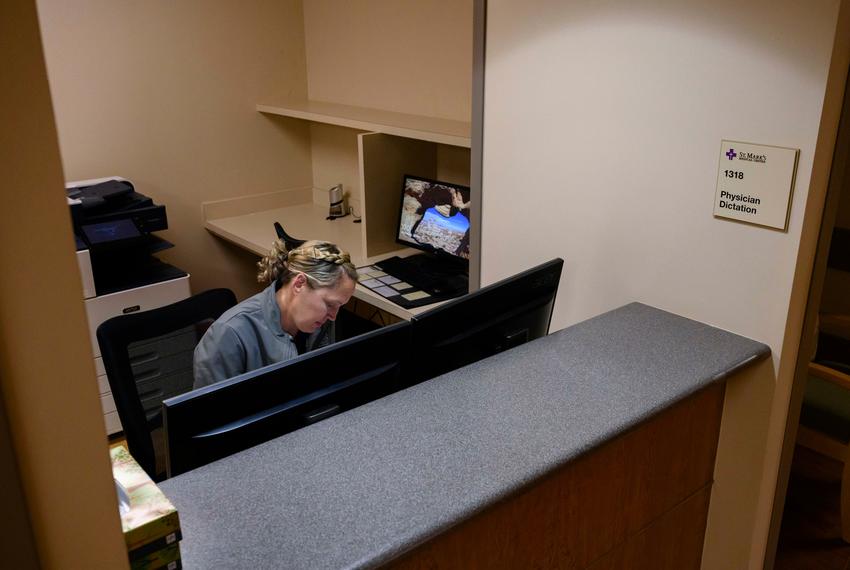 Registered Nurse Stacie Schramek files paperwork on the last day of service at St. Mark’s Medical Center Wednesday, Oct. 11, 2023 in La Grange.