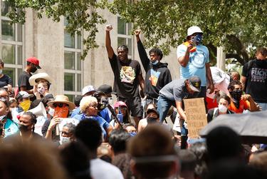 Protesters gathered Friday at Houston City Hall in memory of George Floyd, a black man who was killed during an arrest by a white police officer in Minneapolis.