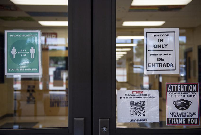 COVID-19 related signs are posted to the entrance to Ott Elementary School in San Antonio on Aug. 11, 2020.