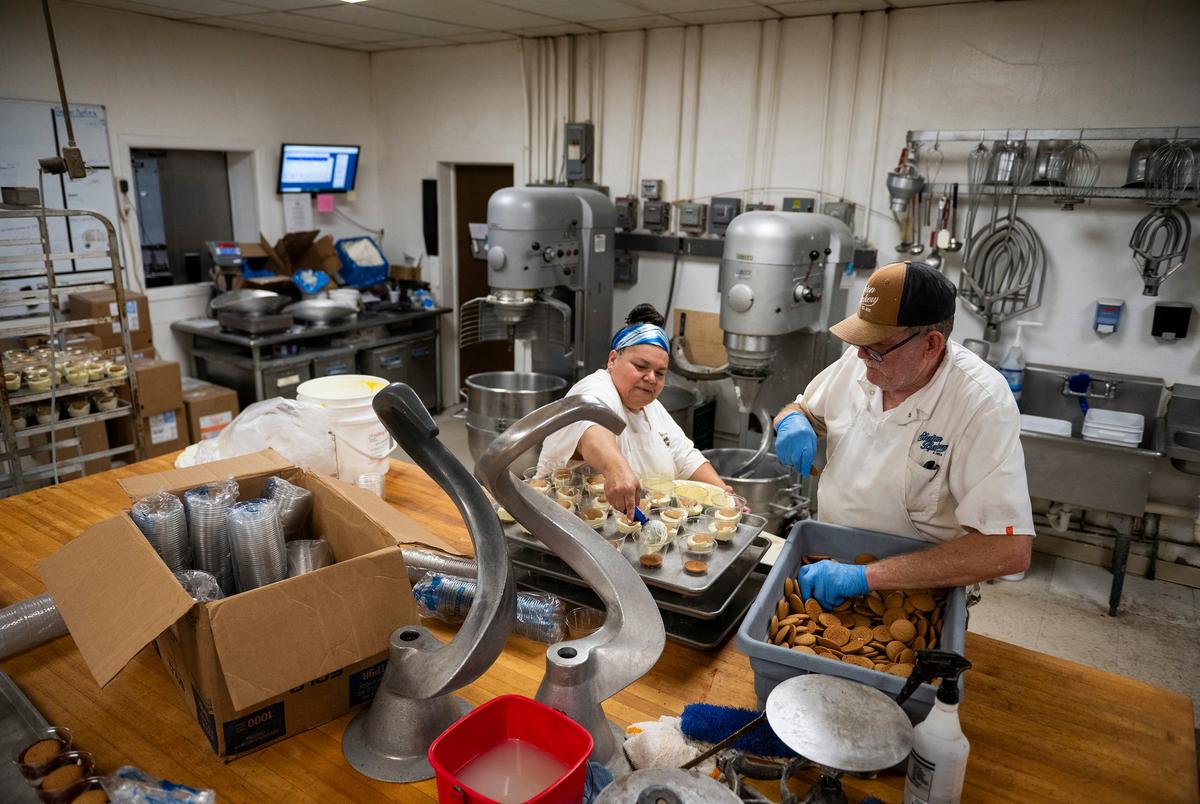 Sonia Marquez, left, and Carl Beard prepare cups of banana pudding for the Texas Banana Pudding Festival in the Slaton Bakery Saturday, Aug. 30, 2025, in Slaton, Texas.