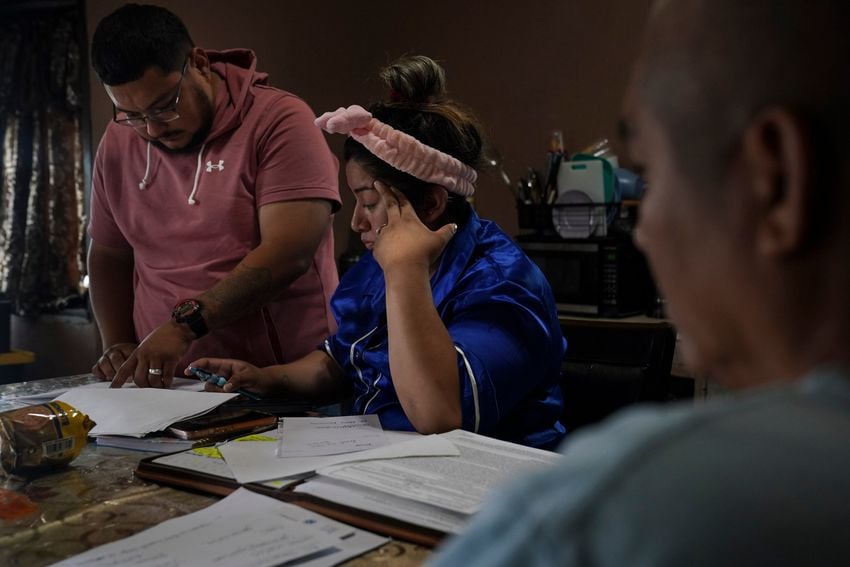 Geovanna Galván, 29, and her husband Jorge De León, 29, look through Mr. Galván’s documents as they talk to his lawyer at their home in Mercedes, Texas on April 23, 2025. 
Gabriel V. Cárdenas for The Texas Tribune