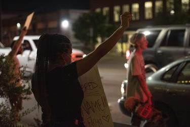 Protesters carry signs against police brutality and in support of Black Lives Matter as they march down Broadway Ave. in downtown Tyler on Monday, June 3, 2020.