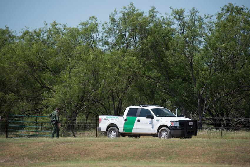 A Border Patrol agent closes a gate at the Eagle Point development in Eagle Pass.  