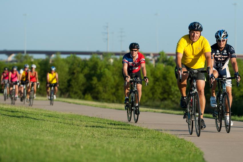 Mayor Pro Tem Stephen Lindsey of Mansfield (yellow) leads the pack during the first Elected Officials Bike Ride in Irving on Aug. 6, 2013, as part of the Transportation and Infrastructure Summit. Riders included nearly 15 mayors and council members from around North Texas with the common goal of promoting biking in their neighborhoods.