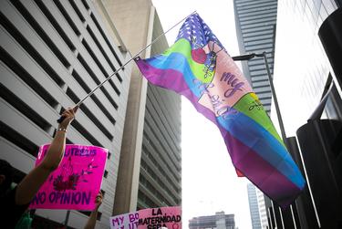 A participant waves a flag during the 2021 Women’s March on Texas in downtown Houston on Saturday, Oct. 2, 2021.