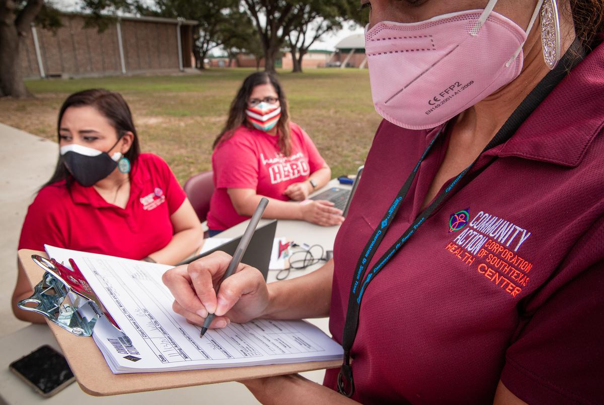 Nelissa Ortiz of Community Action Health Center signs up a patient for a flu shot. Nov. 13, 2020