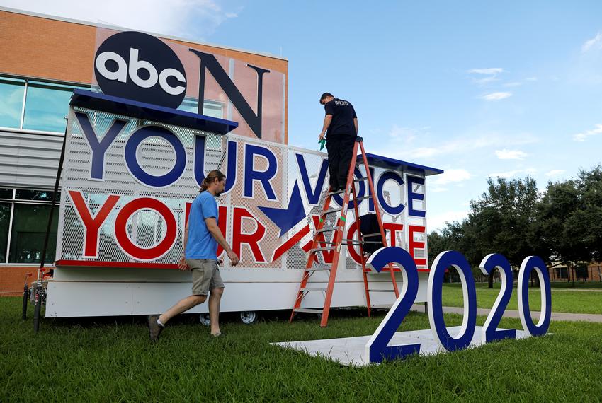 Works crews set up a sign next to the debate hall as preparations continue for the Democratic Presidential Debate in Houston on Sept. 12, 2019.