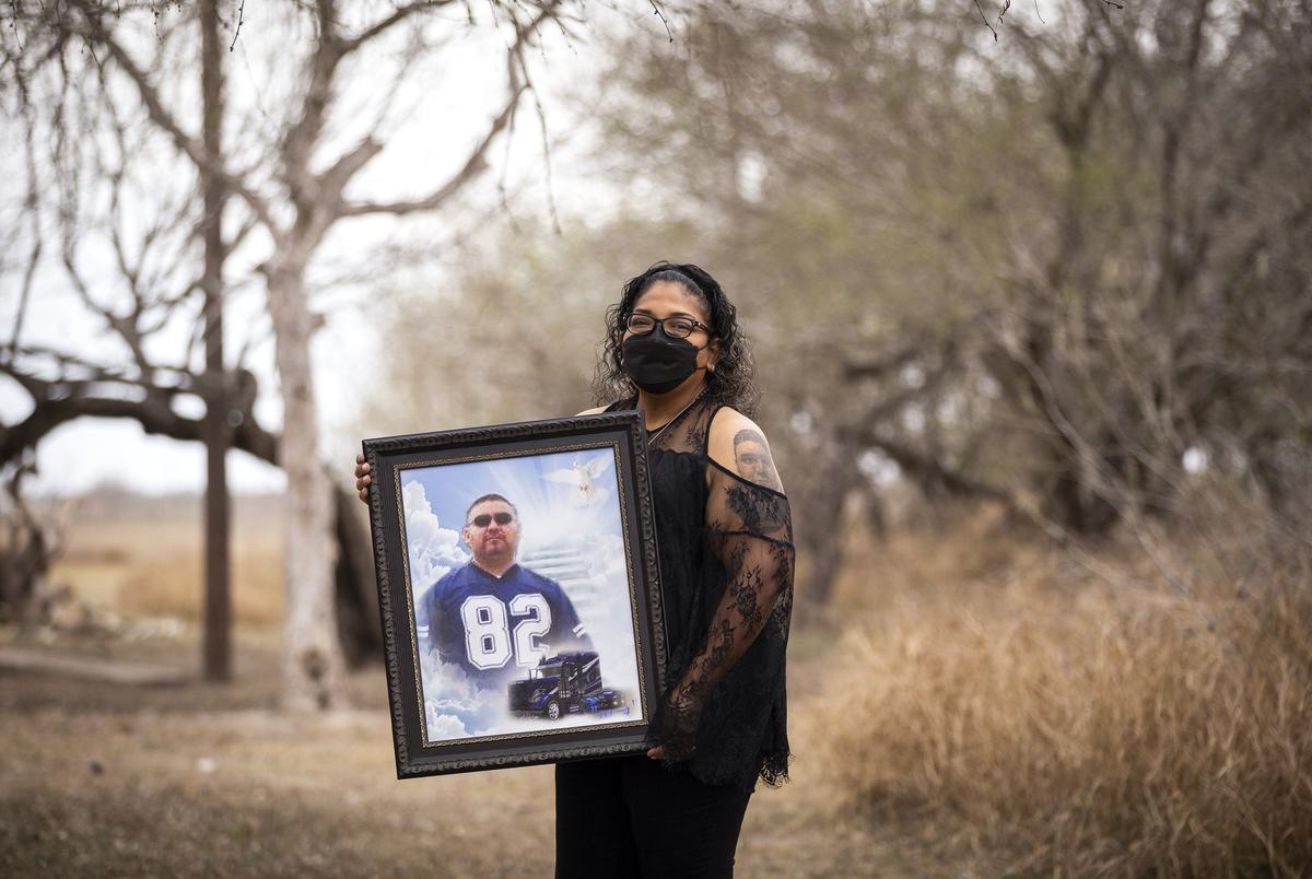 Ana Flores holds a framed photo of her husband Andres Arguelles in Brownsville on March 7, 2021.