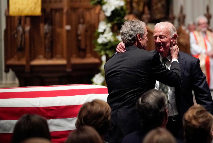 Former President George W. Bush embraces former Secretary of State James Baker after he gave a eulogy during the funeral for former President George H.W. Bush at St. Martin's Episcopal Church, Thursday, Dec. 6, 2018, in Houston. David J. Phillip/Pool via REUTERS