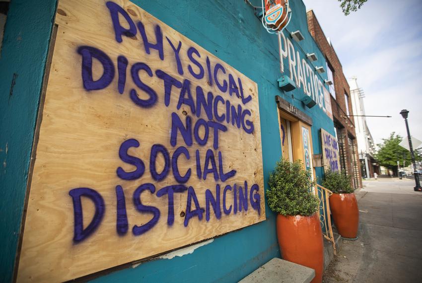 A spray painted sign at Practice Yoga Austin in East Austin refers to the recent coronavirus outbreak that has impacted th...