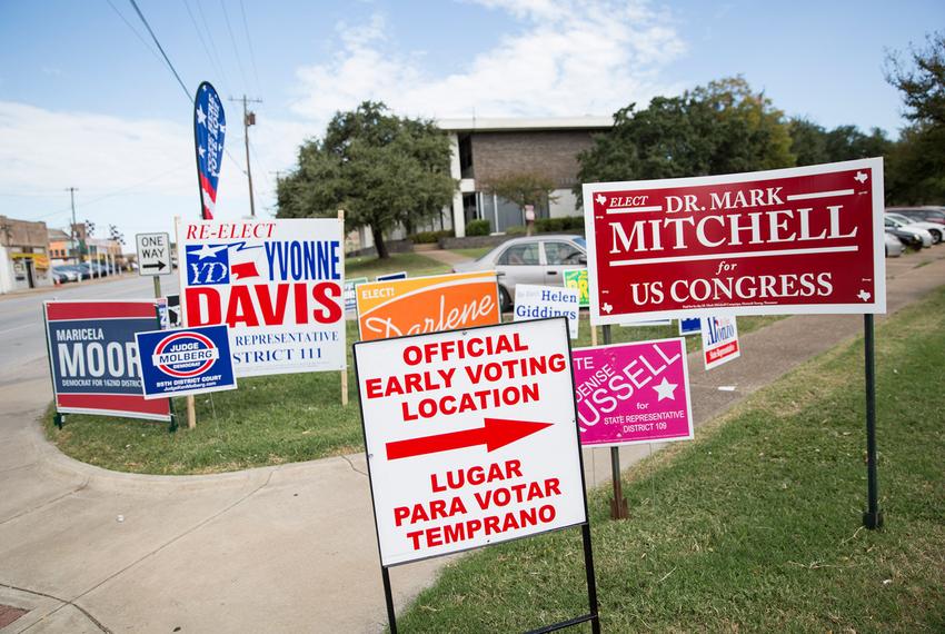 Signs line the property of the Oak Cliff Sub-Courthouse in Dallas, Texas, on the first day of early voting on Monday, Oct. 24, 2016.