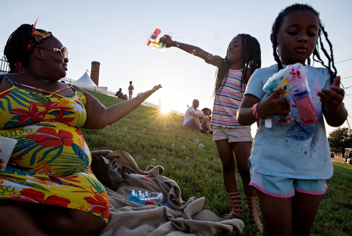 Brianna Williams plays with her daughters Hope and Faith during the 