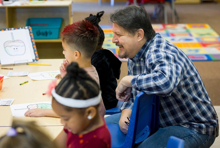 Tim Kaminski, director of operations for Gingerbread Kids Academy and Gingerbread After School Programs, smiles as he interacts with students preparing crafts for a fall celebration on Wednesday, Sept. 26, 2024, in Richmond, TX.