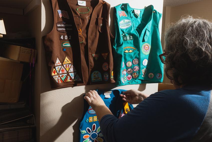 Heather Crawford begins to pack Cass's girl scout clothing as the family prepares to move out of state due to recent attacks by state officials on trans children, at their home in Austin, TX on July 14, 2022.