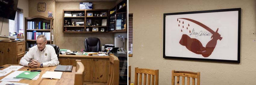 Left: Sheriff Roy Boyd at a table in his office in Goliad County. Right: Boyd has a Dimmit Flag — a flag raised in Goliad during the Texas Revolution — signed by Gov. Abbott hanging in his office.