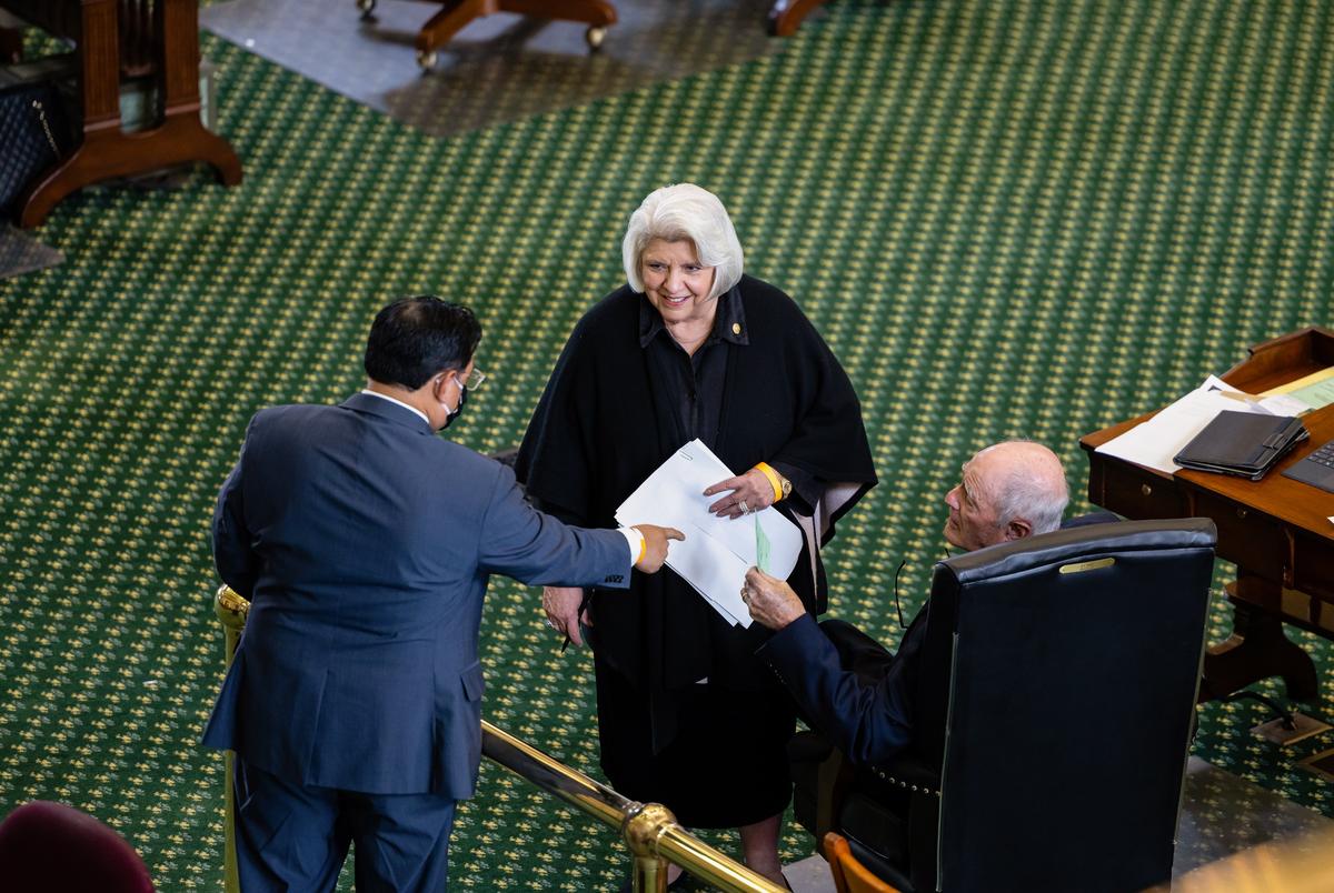 State Sen. Judith Zaffirini, D-Laredo, and state Sen. Kel Seliger, R-Amarillo, speak to an aid on the senate floor on April 12, 2021.