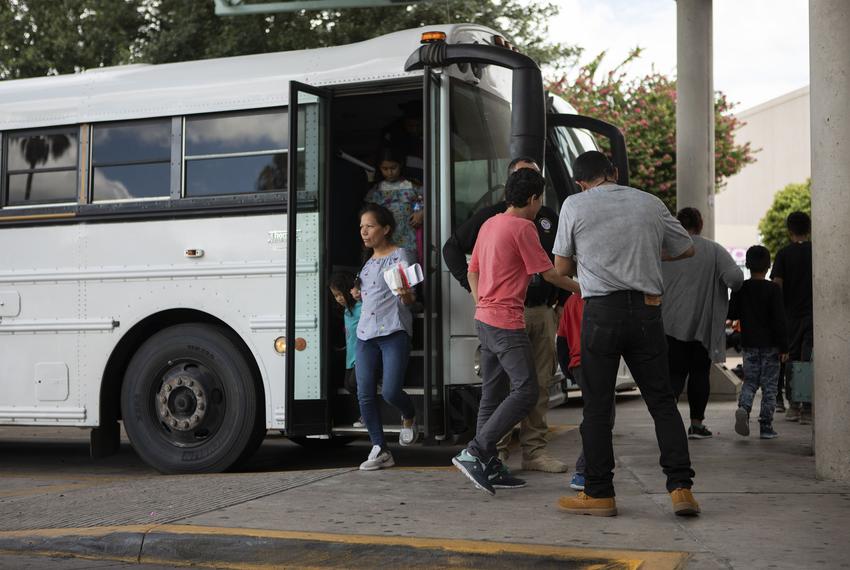 A group of migrants exit an immigration bus at the McAllen Central Station in downtown McAllen on June 25, 2019.