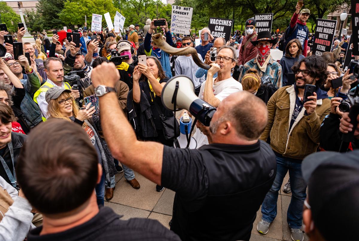 Infowars Founder Alex jones speaks to a crowd gathered at the Texas State Capital in protest of economic shutdowns amid the coronavirus pandemic.