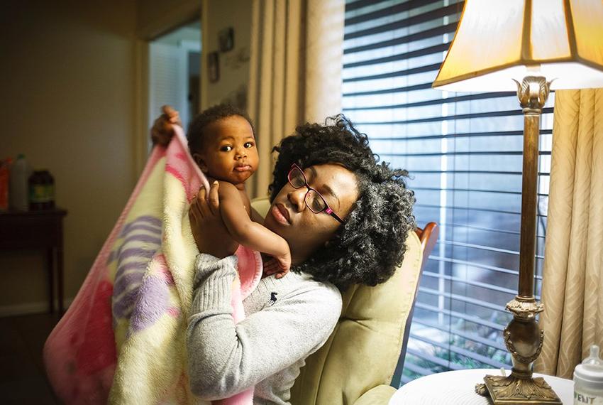 Jasmine Johnson, with 10-month-old daughter Rain, lost her Medicaid coverage and was told she could not re-enroll, even though federal law allows former foster children like Johnson to stay in the health insurance program until they turn 26.