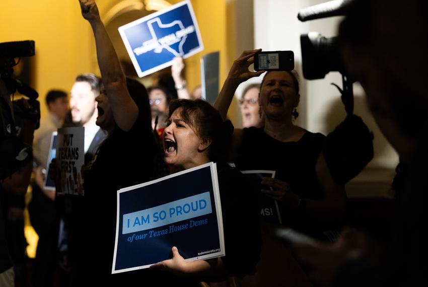 A crowd cheers as representatives walk into the Texas House on Aug. 18, 2025. Texas Democrats left the state to fight redistricting at the national level, returning after two weeks.